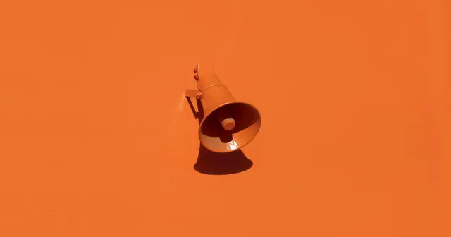 Orange megaphone on an orange wall, a symbol of choosing an advertising channel