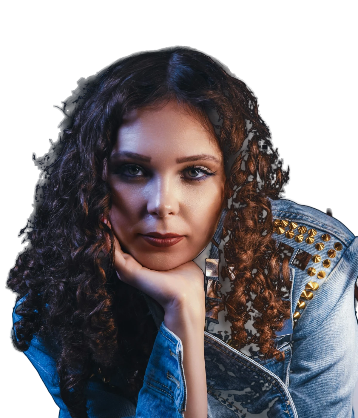 Portrait of Nadia Vale, a woman with long curly hair in a studded denim jacket